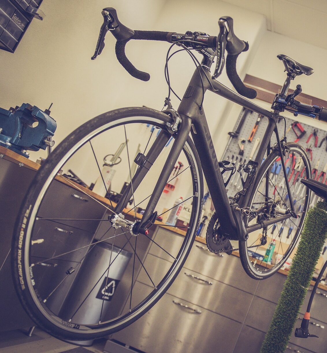 Bilden visar ett cykelrum med mek station. Cykelställ i två våningar med cykellift för enklare cykelparkering.